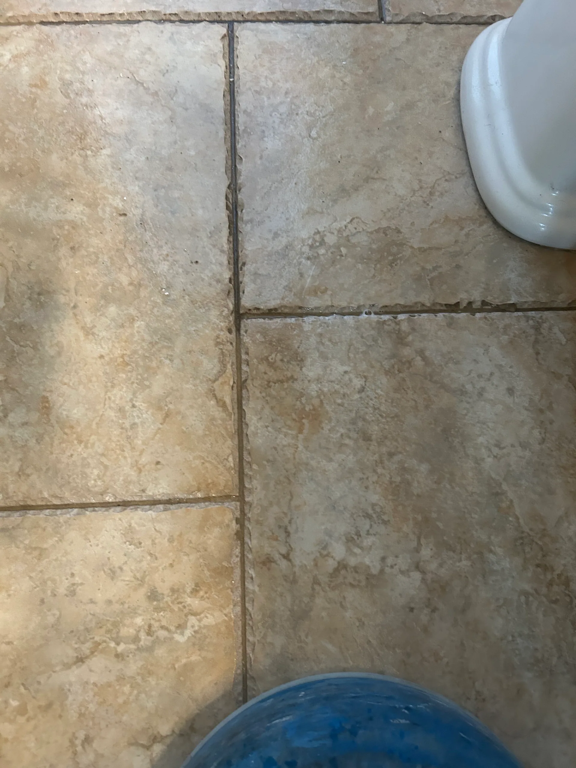 beige travertine look tile toilet base blue spinner bathroom