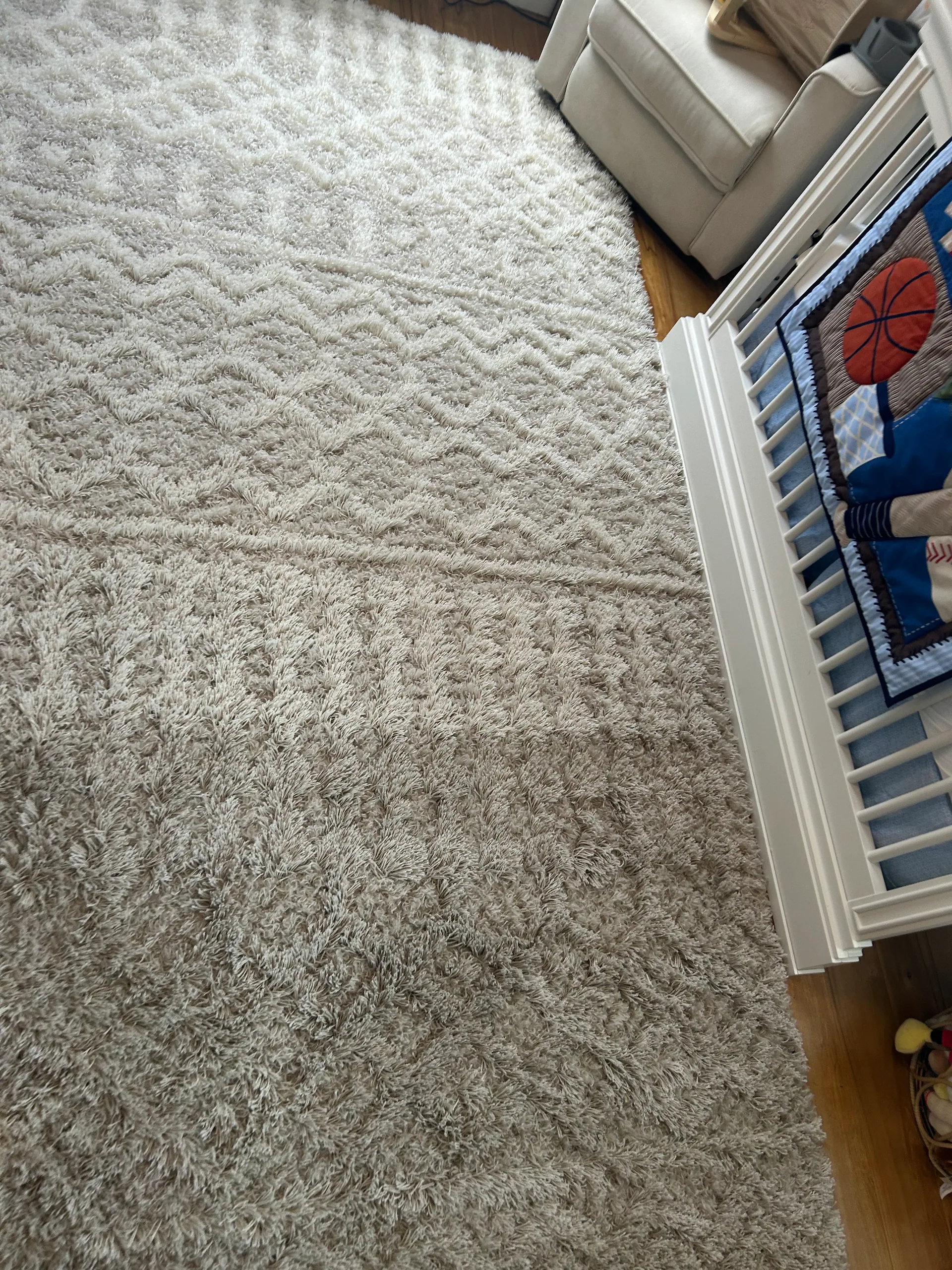 cream shag area rug nursery white crib hardwood