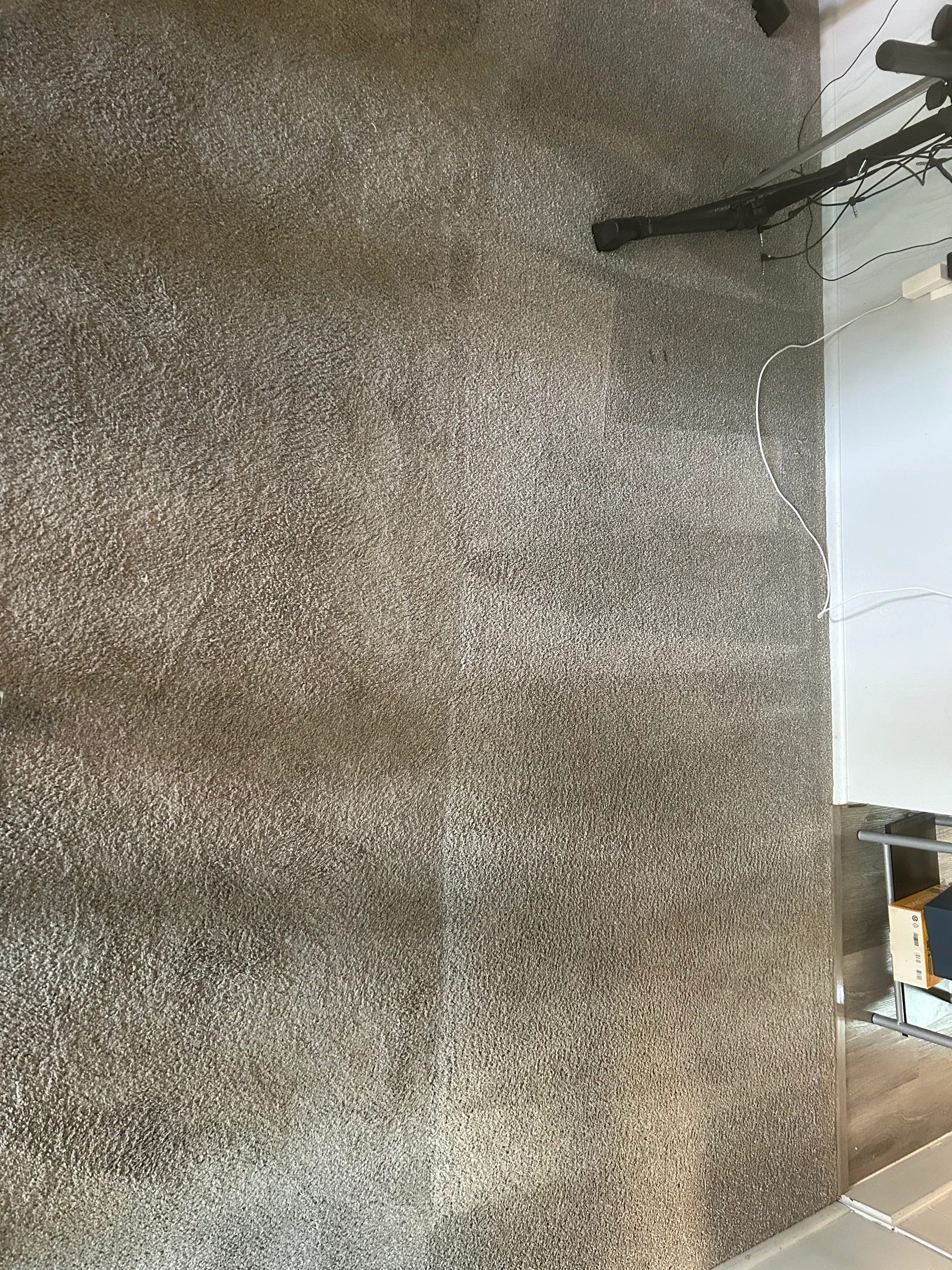 gray carpet wand strokes office desk cords wood plank edge o