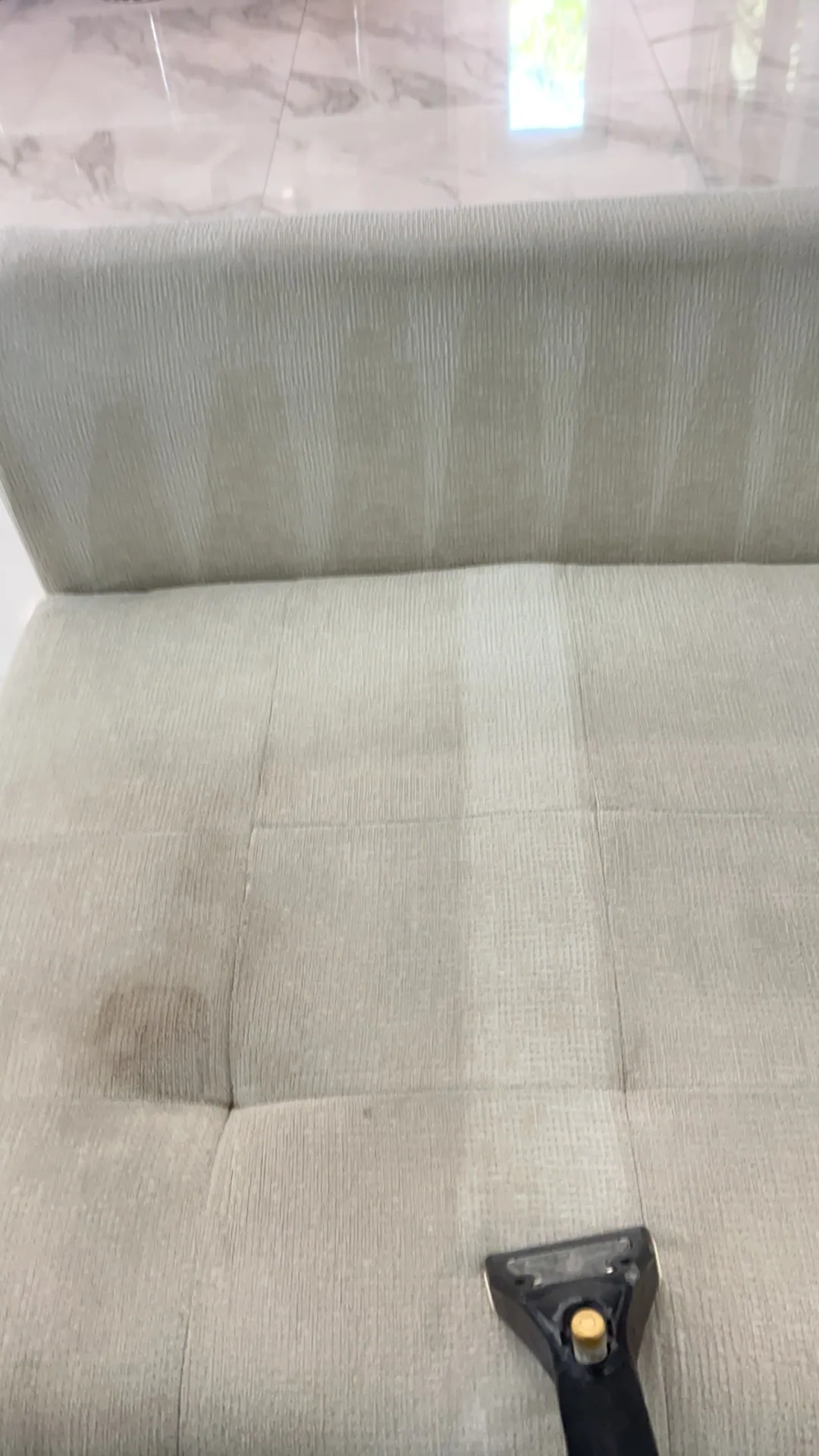 pale green tufted sofa brown stain marble tile
