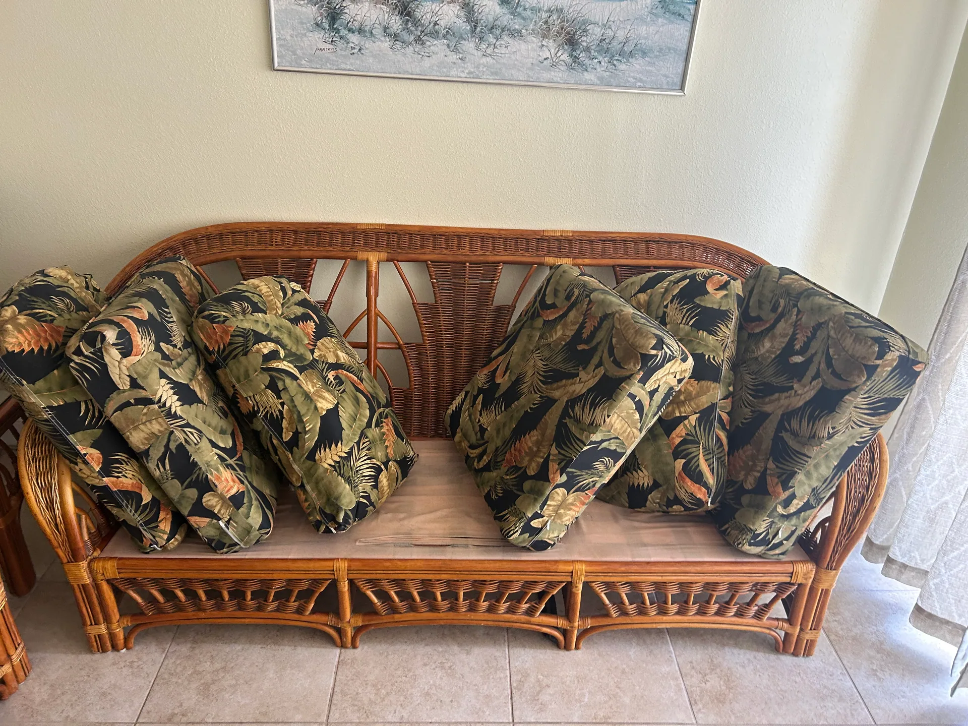 rattan sofa tropical print cushions propped drying